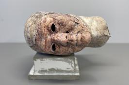 Plaster sculpture of a head lying on its side